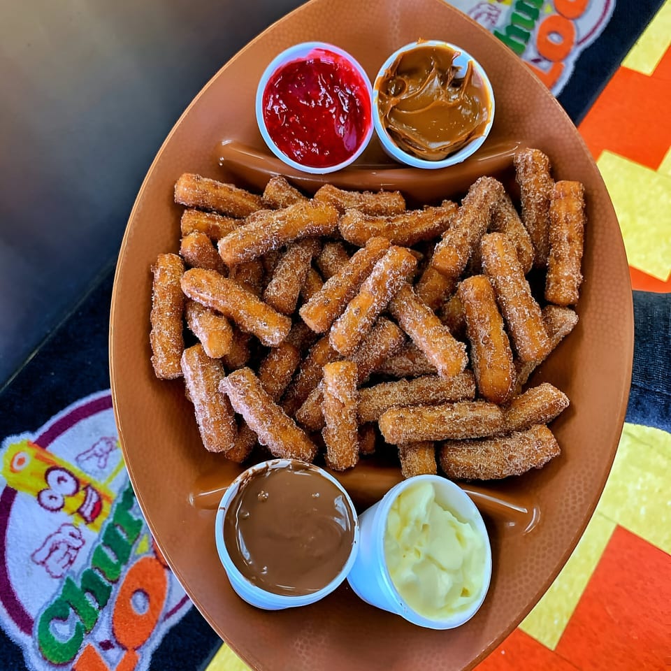 Churrito Loco churros with four dipping sauces: strawberry, dulce de leche, chocolate, and vanilla.